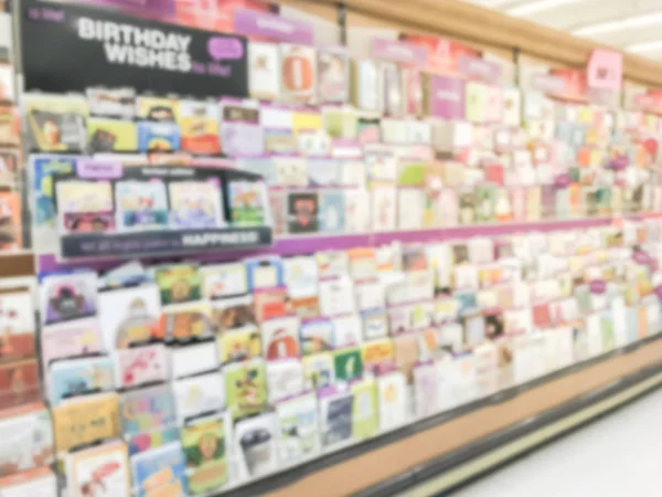 Blurred abstract greeting cards and balloons display at grocery store in Texas, America.