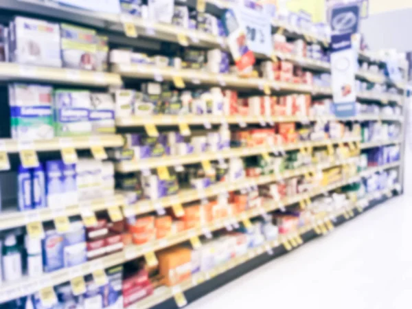 Vintage tone blurred abstract wide selection of of vitamin and supplement on shelves display with discounted price tags at grocery store in Texas, America.