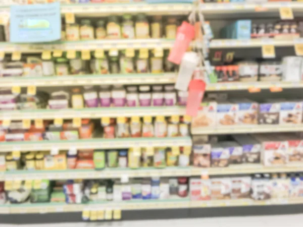 Blurred image variation of vitamin and supplement on shelves display with discounted price tags at grocery store in Texas, America.