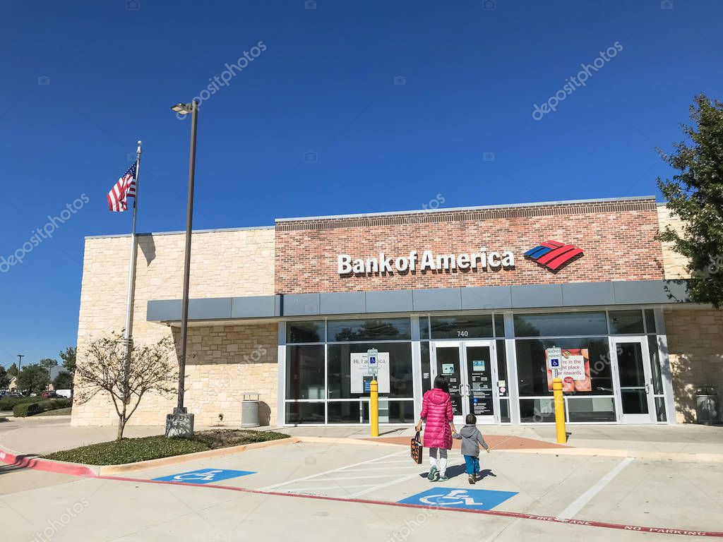 COPPELL, TX, US-NOV 18, 2018:Customers enter branch office of Bank of America with American flag. Ranked 2nd on list of largest banks in the US by assets, headquartered in Charlotte, North Carolina