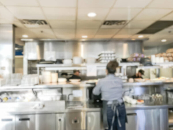 Motion blurred waitress serving ordered dishes from kitchen of breakfast restaurant in Chicago, USA