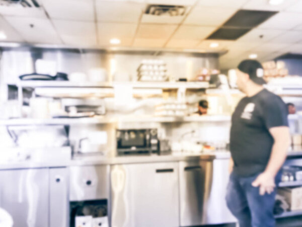 Blurred abstract preparing, cooking ordered dishes from kitchen of breakfast restaurant in Chicago, USA
