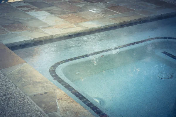 Working outdoor Jacuzzi pool with clean transparent turquoise water, hot bath spa tub relaxes at apartment complex in Texas, USA