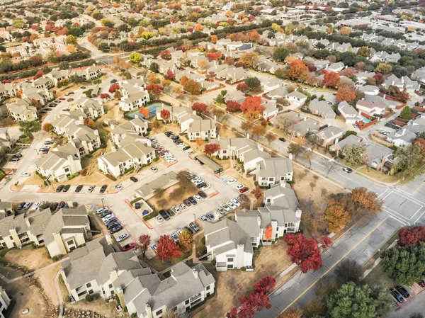 Aerial view Valley Ranch planned unit development with community tennis court in Dallas suburb of Irving, Texas, USA. Colorful fall foliage leaves, row of single-family homes, urban sprawl subdivision
