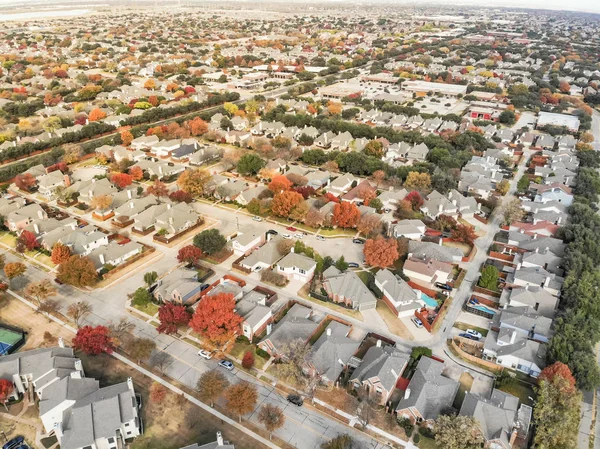 Beautiful aerial view of Valley Ranch planned unit development in the Dallas, Texas suburb of Irving, Texas, USA. Colorful fall foliage leaves near row of single-family homes, urban sprawl subdivision