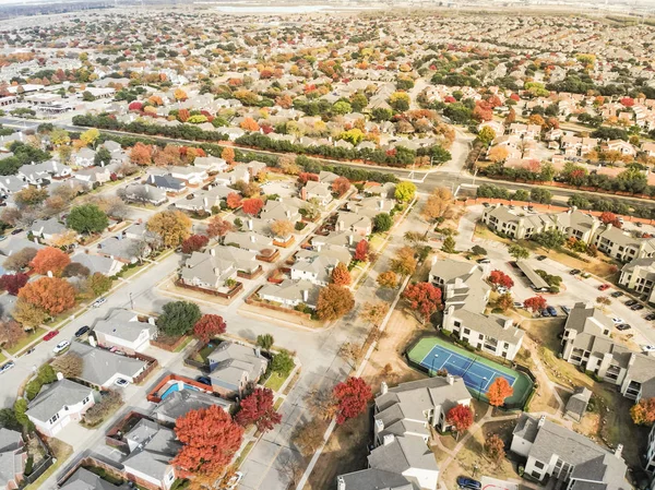 Aerial view Valley Ranch planned unit development with community tennis court in Dallas suburb of Irving, Texas, USA. Colorful fall foliage leaves, row of single-family homes, urban sprawl subdivision