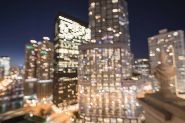 Abstract blurred defocused of Chicago riverside office and residential building high-rise. Aerial view urban night light bokeh from illuminated skylines