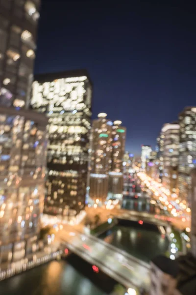 Abstract blurred defocused of Chicago riverside office and residential building high-rise. Aerial view urban night light bokeh from illuminated skylines