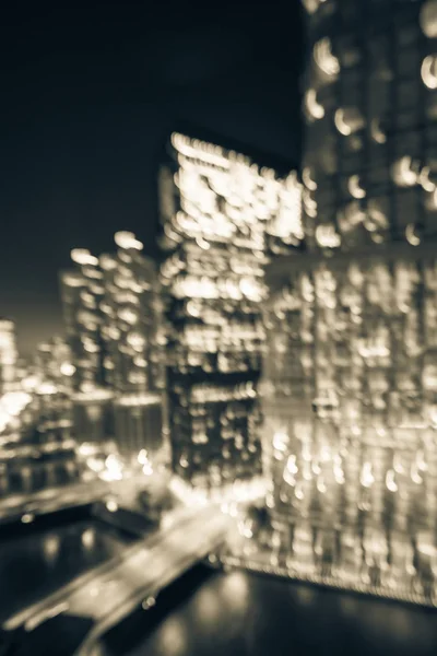 Vintage tone motion blurred defocused of Chicago riverside office and residential building high-rise. Aerial view urban night light bokeh from illuminated skylines