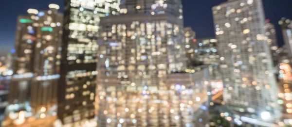 Panorama abstract blurred defocused of Chicago riverside office and residential building high-rise. Aerial view urban night light bokeh from illuminated skylines