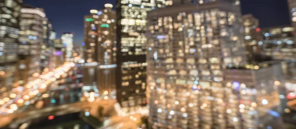 Panorama abstract blurred defocused of Chicago riverside office and residential building high-rise. Aerial view urban night light bokeh from illuminated skylines