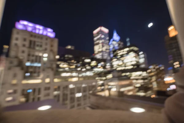 Abstract blurred defocused of Chicago riverside office and residential building high-rise. Aerial view urban night light bokeh from illuminated skylines