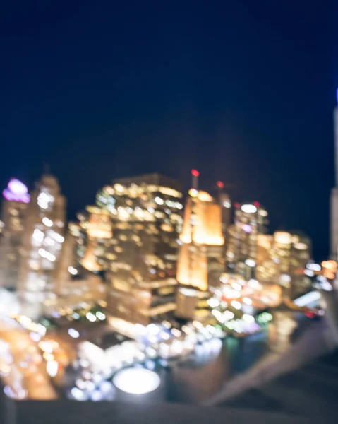 Vintage tone motion blurred defocused of Chicago riverside office and residential building high-rise. Aerial view urban night light bokeh from illuminated skylines