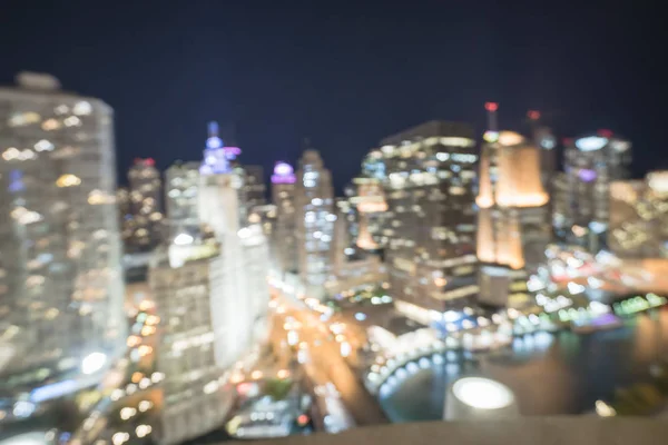 Abstract blurred defocused of Chicago riverside office and residential building high-rise. Aerial view urban night light bokeh from illuminated skylines