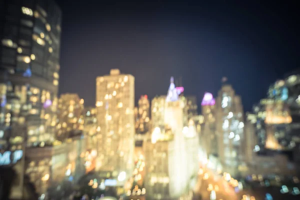 Vintage tone motion blurred defocused of Chicago riverside office and residential building high-rise. Aerial view urban night light bokeh from illuminated skylines