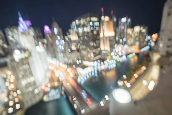 Abstract blurred defocused of Chicago riverside office and residential building high-rise. Aerial view urban night light bokeh from illuminated skylines