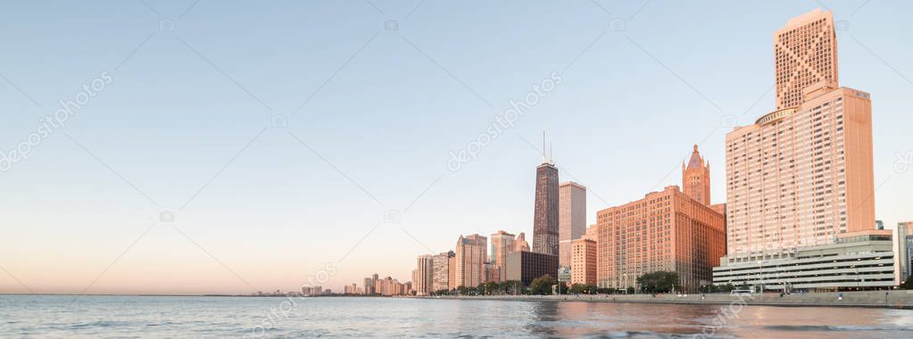 Panorama view of Chicago skylines along Lake Shore Drive reflection from beach park at sunrise