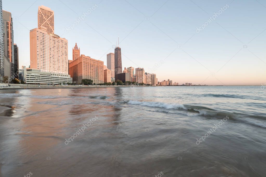 Chicago skylines along Lake Shore Drive reflection from beach park at sunrise