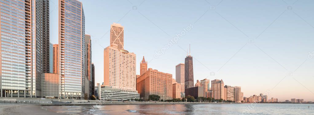 Panorama view of Chicago skylines along Lake Shore Drive reflection from beach park at sunrise