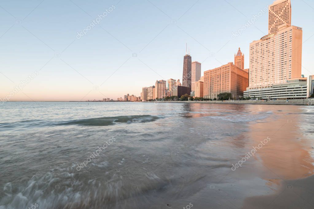 Chicago skylines along Lake Shore Drive reflection from beach park at sunrise