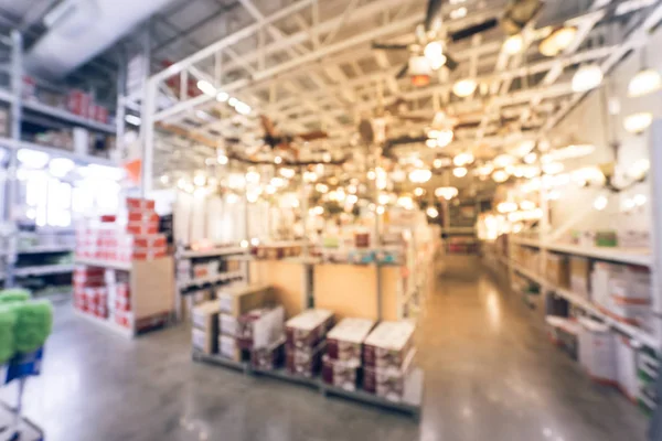 Blurry abstract wide selection of ceiling fans with lights on display at home improvement store in America. Defocused background variety of coastal, classic, modern, cottage, rustic, industrial, LED