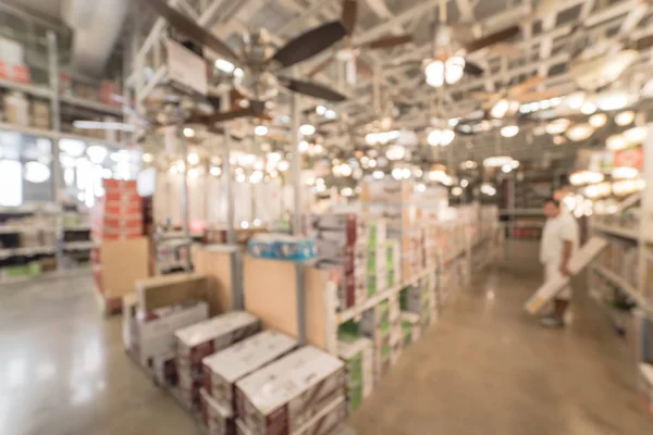 Motion blurred customer shopping for ceiling fans with lights on display at home improvement store in USA. Defocused background variety of coastal, classic, modern, cottage, rustic, industrial, LED