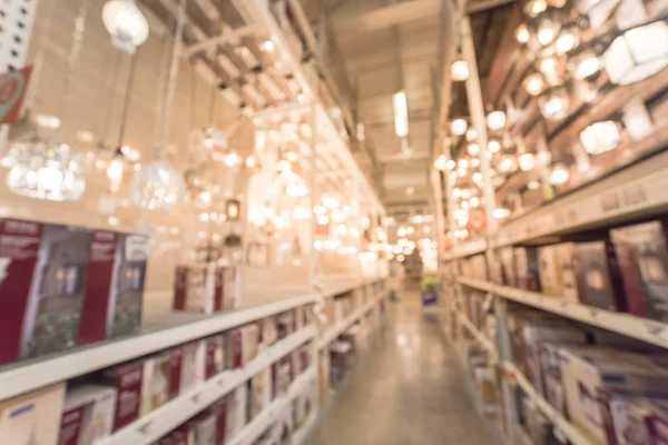 Blurry abstract wide selection of ceiling fans with lights on display at home improvement store in America. Defocused background variety of coastal, classic, modern, cottage, rustic, industrial, LED
