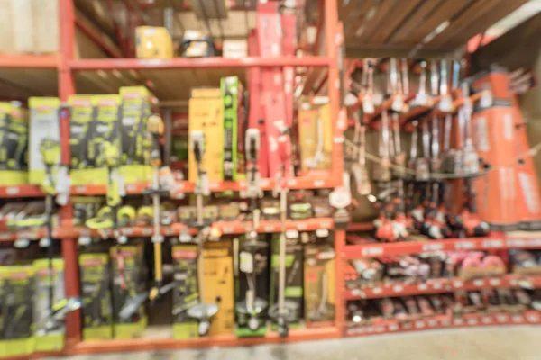 Blurry background garden trimmer tools on shelf display at home