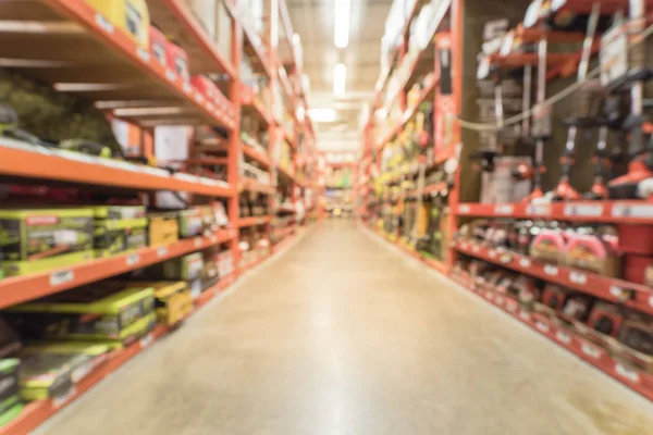 Blurry background garden trimmer tools on shelf display at home