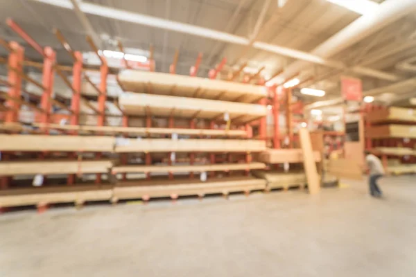 Blurred motion customer cutting lumber at hardware store in America. Wide selection of exterior and construction lumber, composites, ground contact pressure