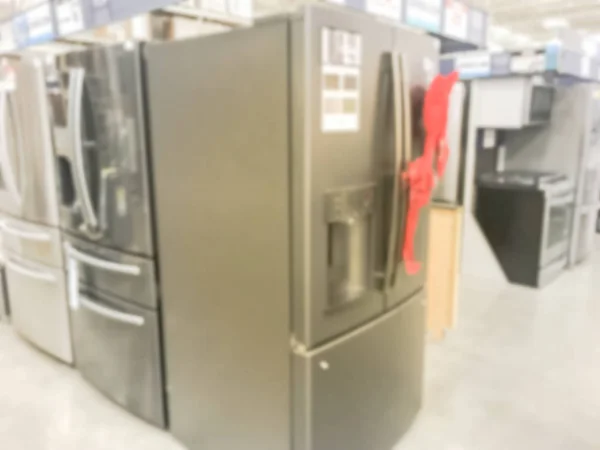Motion blurred brand new door in door refrigerators with red bow tie at home improvement store in America