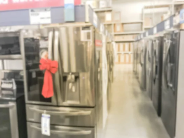 Motion blurred brand new door in door refrigerators with red bow tie at home improvement store in America