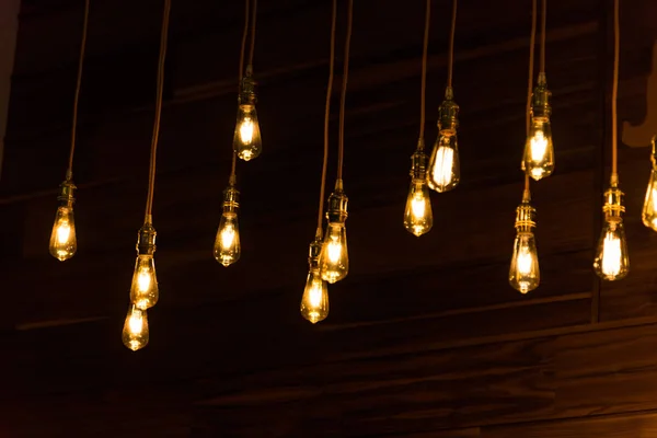 Close Set Vintage Glowing Light Bulbs Hanging Black Background Decorative — Stock Photo, Image