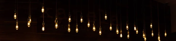 Panorama View Set Vintage Glowing Light Bulbs Hanging Black Background — Stock Photo, Image