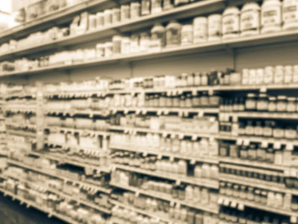 Vintage tone blurred abstract variety of vitamin and supplement products on display at grocery store in Texas, America