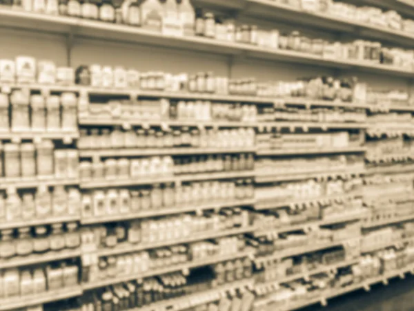 Vintage tone blurred abstract variety of vitamin and supplement products on display at grocery store in Texas, America