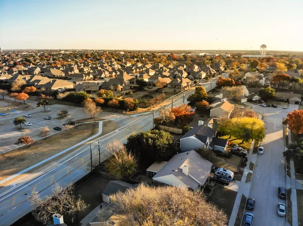 Top drone view over residential homes in large suburb of Dallas, Texas, USA. Wells branch and shoreline suburban with local street and colorful autumn leaves