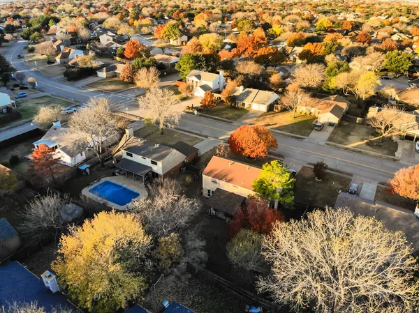 Top drone view over residential homes in large suburb of Dallas, Texas, USA. Wells branch and shoreline suburban with local street and colorful autumn leaves