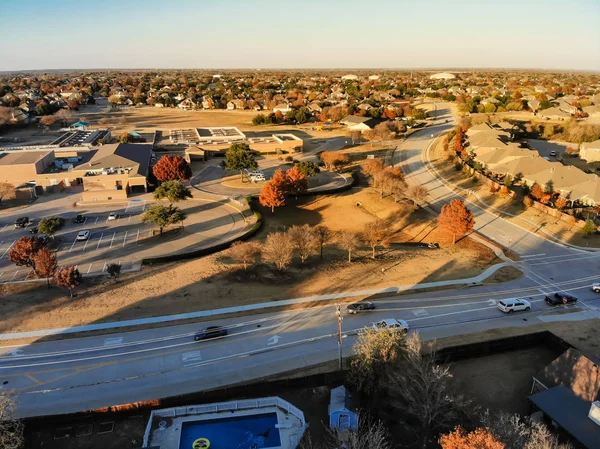 Aerial drone view real state background of residential neighborhood with school district suburbs Dallas, Texas, USA. Wells branch and shoreline suburban and colorful autumn leaves