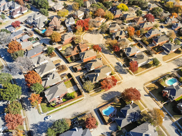 Top view residential area with cul-de-sac (dead end), well lined and branches house and colorful fall foliage. Straight down look as satellite style suburban Dallas, Texas, USA