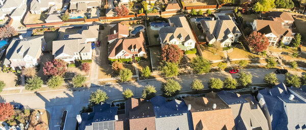 Panorama aerial view well lined and branched of single-family detached homes in Cedar Hill, a city in Dallas and Ellis counties, 16 miles southwest of downtown Dallas. Color autumn leaves