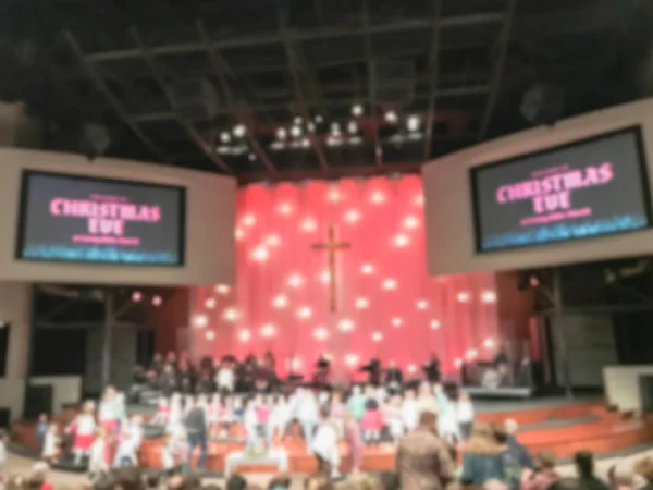 Blurred abstract story time for children on church stage during Christmas Eve service in America