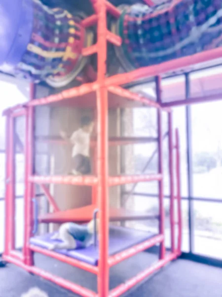 Blurred motion indoor playground with natural lights from glass windows and kids playing