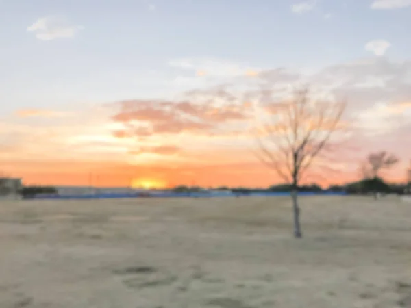 Blurry background dramatic sunset at city park with pathway in s — Stock Photo, Image