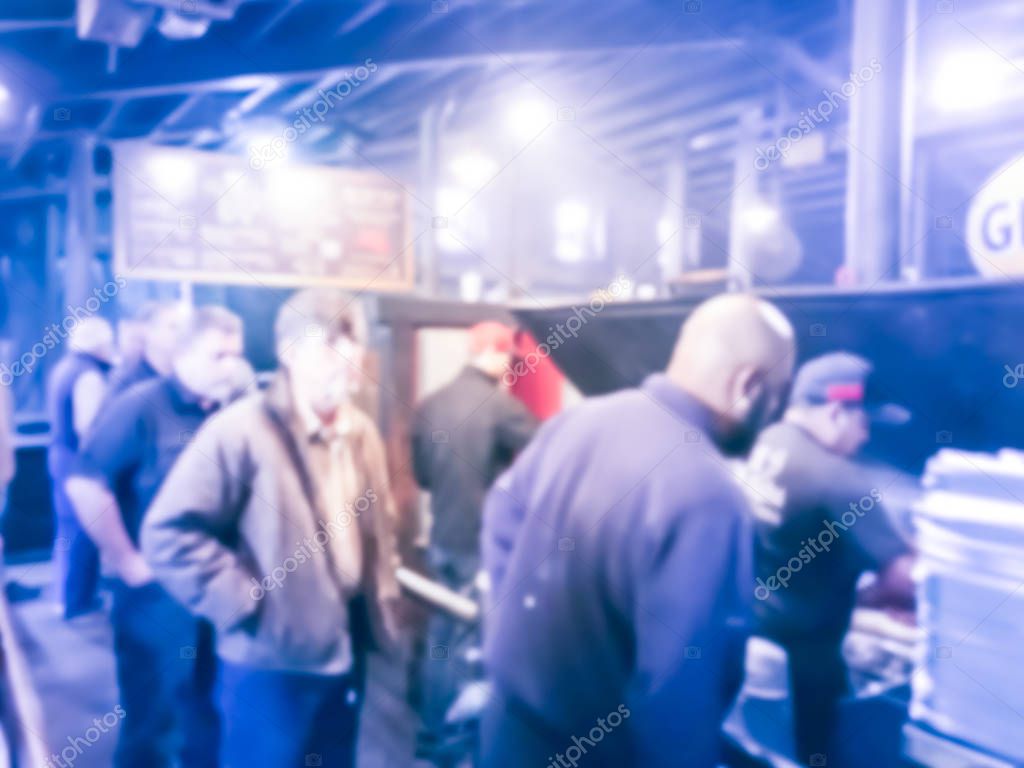 Blurry background crowed people waiting at Texas-style barbecue 