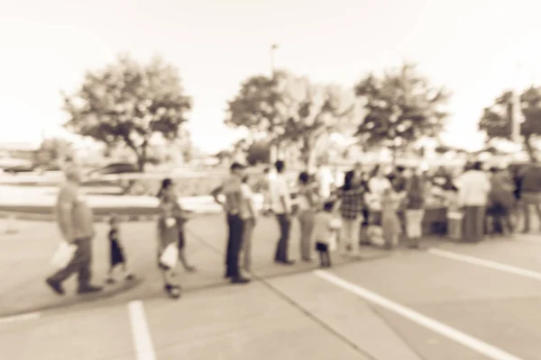 Filtered image blurry background long line of people waiting for — Stock Photo, Image