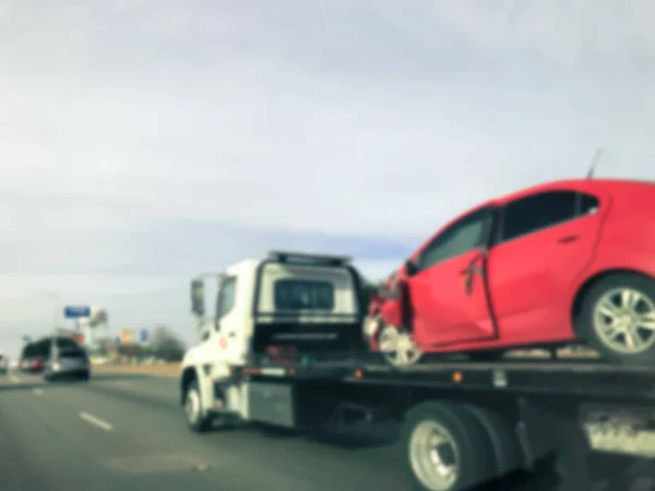 Filtered image blurry background rear view of smashed car on tow truck after crash — Stock Photo, Image