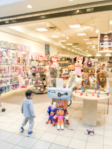 Blurry background toddler boy choosing toy at toys tore in USA — Stock Photo, Image