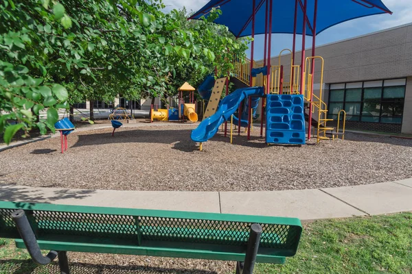 Bench and playground with colorful structure equipment near Dallas, Texas