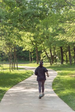 ABD'de parkta yürüyen sağlıklı Beyaz bayanın arka görünümü